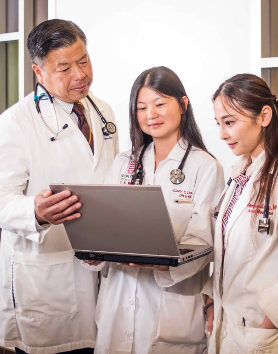 Doctors looking at laptop