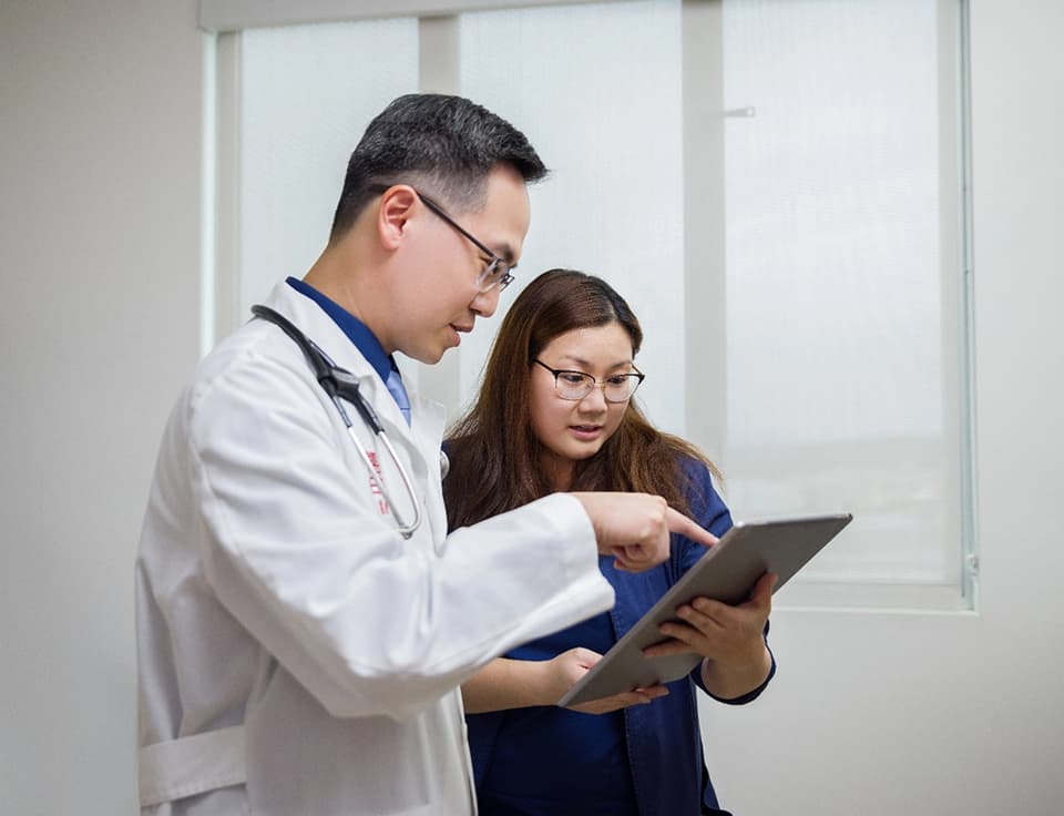 Doctor pointing at clipboard